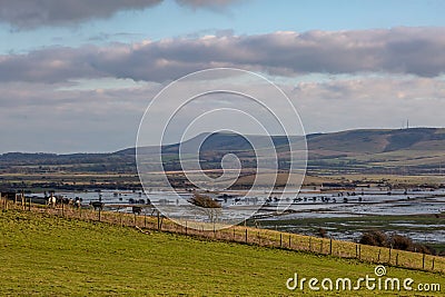 Looking out towards Firle Beacon from the South Downs near Lewes, with flooded fields at Iford inbetween Stock Photo