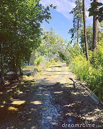 Flooded hiking trail along lakeshore Stock Photo