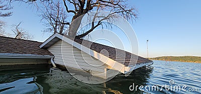Flooded home and garage on fish lake Stock Photo