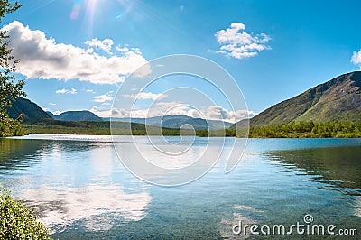 The flooded river overran the valley in tundra at summer season. The Khibiny Massif are the highest mountains of the Kola Stock Photo