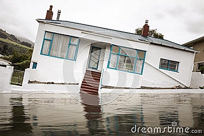 Flooding with a crooked house Stock Photo