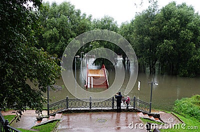 Flooding of a park with a bridge due to rains Editorial Stock Photo
