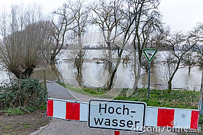 Flooding river creek after a flood water with a fallen tree shows the forces of nature and the need for insurance against dangerou Stock Photo