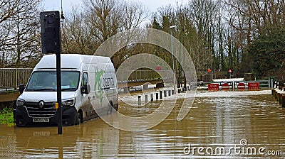 Flooding river Ouse causing bridge and road to be shut off. Van stuck in flood. Editorial Stock Photo