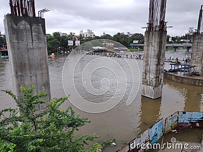 Flooding river almost swallos small bridge in pune Editorial Stock Photo