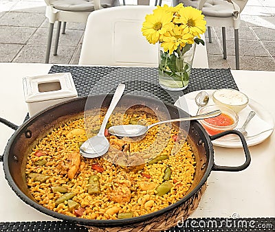 Typical Spanish paella one dish with homemade garlic and fresh tomato sauce Stock Photo