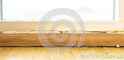 Floor moldings and paint color swelling on old white wall Stock Photo