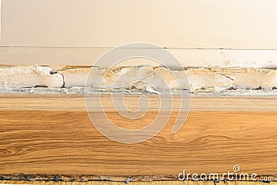 Floor moldings and paint color swelling on old white wall Stock Photo