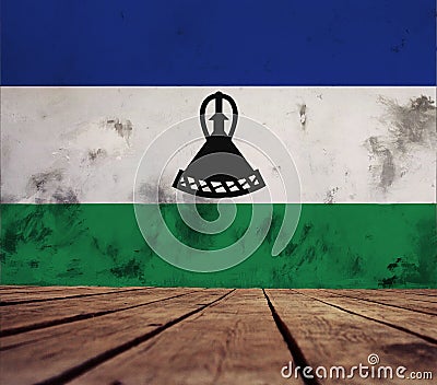 The floor of planks and plastered wall with the Kingdom of Lesotho flag. Stock Photo