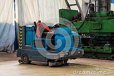 Floor sweeper and washer scrubber drier car in an industrial building Stock Photo