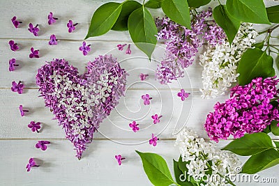 Floral arrangement of lilac flowers and heart made of lilac petals Stock Photo