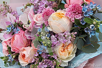 Floral backdrop, background. Flowers in bloom. Yellow pink blue bouquet with roses close-up Stock Photo