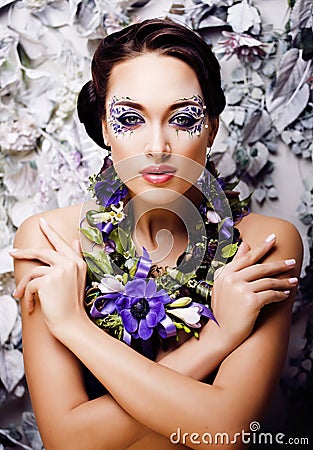 Floral face art with anemone in jewelry, sensual young brunette Stock Photo