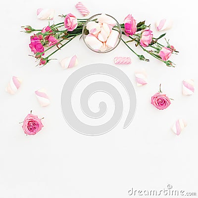 Floral feminine composition with pink roses and marshmallow on white background. Top view. Flat lay Stock Photo