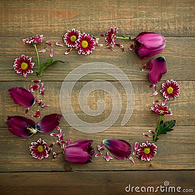 Floral frame of pink flowers on wood background. Flat lay, Top view. Stock Photo