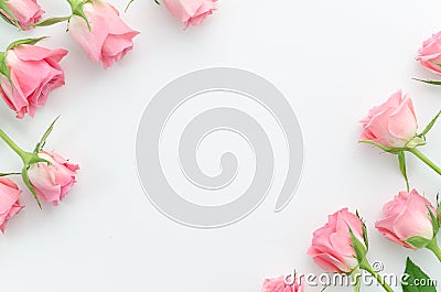 Floral pattern, frame made of beautiful pink roses on white background. Flat lay, top view. Valentine`s background Stock Photo