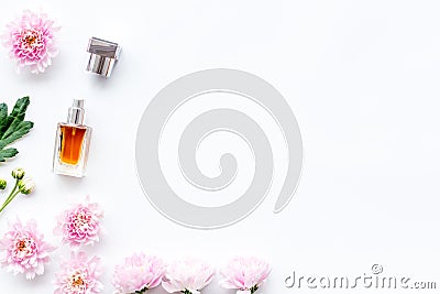 Floral perfume for women. Bottle of perfume near delicate pink flowers on white background top view space for text Stock Photo