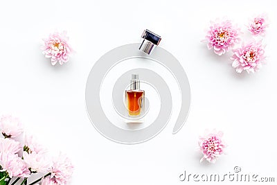 Floral perfume for women. Bottle of perfume near delicate pink flowers on white background top view pattern Stock Photo