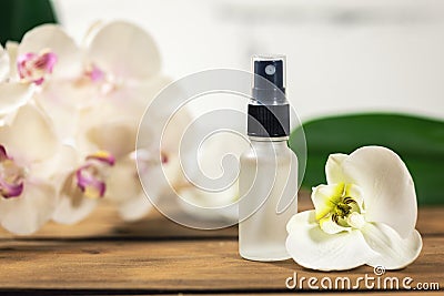 Floral scent perfume sprayer with orchid flower Stock Photo