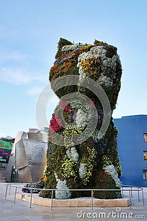 Floral sculpture of Puppy by Jeff Koons in front of Guggenheim Museum Bilbao. Editorial Stock Photo