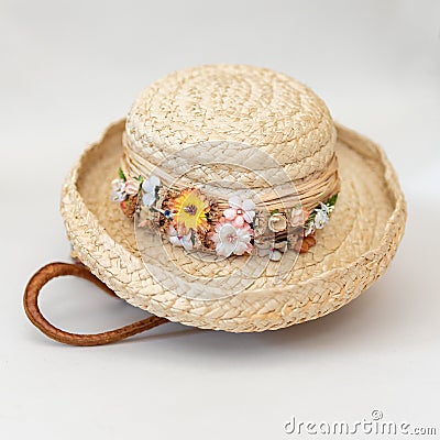 Floral trimmed Spring straw hat sitting on top of handmade woven basket Stock Photo