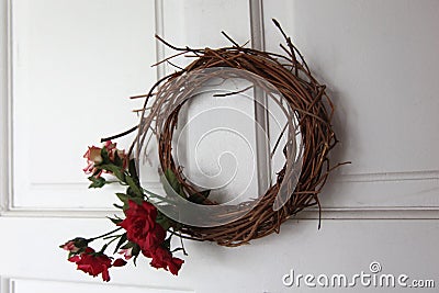 Floral wreath made up of flowers and dried twigs Stock Photo