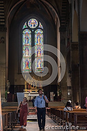 Florence ITALY - August 6, 2023 - Dark interior of the Basilica di Santa Trinita with people Editorial Stock Photo