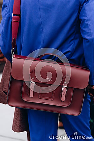 Florence, Italy - January 12, 2023: fashioner wearing The 15 Inch Batchel - Oxblood shoulder bag. Fashion blogger outfit Editorial Stock Photo