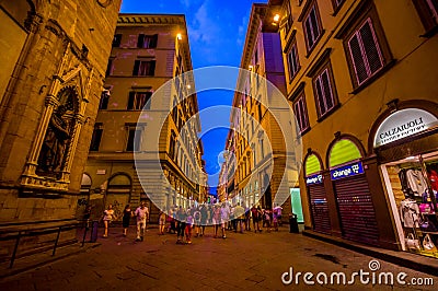 FLORENCE, ITALY - JUNE 12, 2015: Florence at night. Shops open late on summer, people visiting historical center, nice Editorial Stock Photo