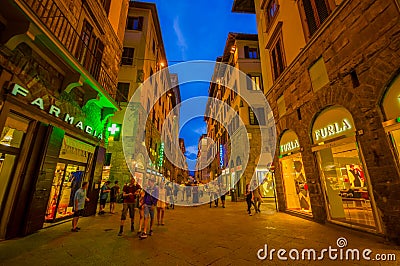 FLORENCE, ITALY - JUNE 12, 2015: Florence at night. Shops open late on summer, people visiting historical center, nice Editorial Stock Photo