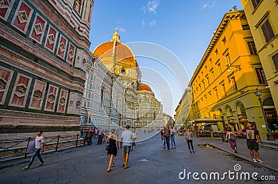 FLORENCE, ITALY - JUNE 12, 2015: Large street on the side of Florence Cathedral, people walking around minutes before Editorial Stock Photo