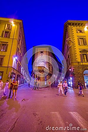 FLORENCE, ITALY - JUNE 12, 2015: People walking late at night on summer in Florence, lights on purple tone Editorial Stock Photo