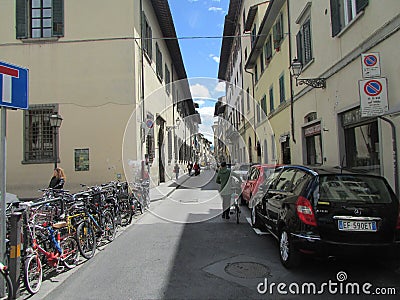 Florence, Italy, narrow medieval streets, main transport - scooters and bicycles. Editorial Stock Photo
