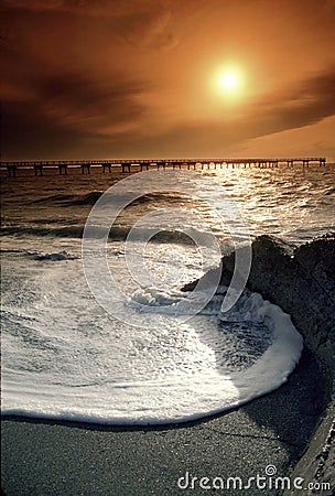 Florida Gulf Coast Sunset With Large Wave and Warm Sky Stock Photo