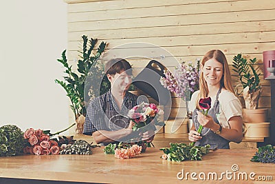 Florist and assistant in flower shop delivery make rose bouquet Stock Photo