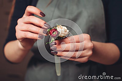 Florist hands creating flower decoration closeup. Stock Photo