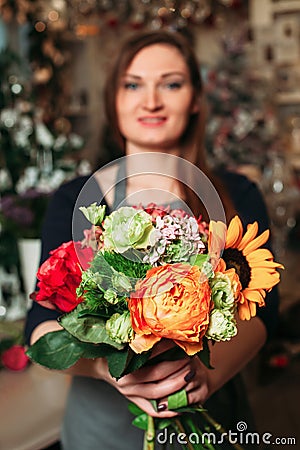 Florist hands holding bouquet flowers closeup. Stock Photo