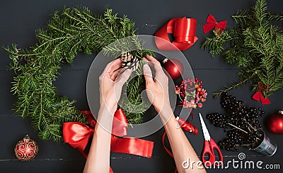 Florist hands making Christmas wreath Stock Photo