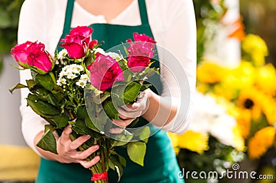 Florist hands showing red roses bouquet flowers Stock Photo