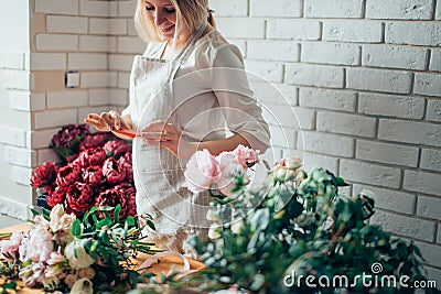 Florist photographing bouquet at phone. Mibile photography Stock Photo