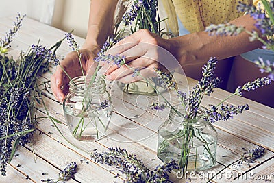 Florist at work: Creating small bouquets of natural lavender flo Stock Photo