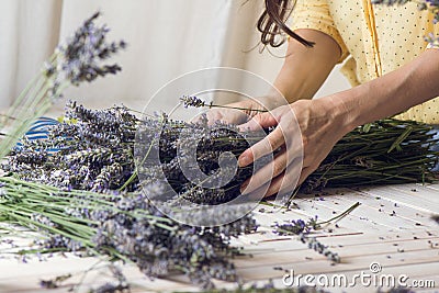 Florist at work: woman creating bouquet of natural lavender flow Stock Photo