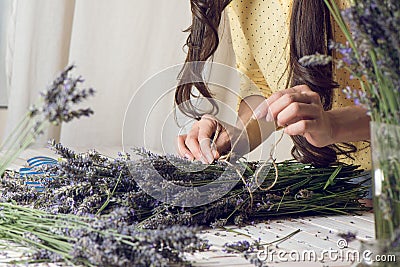 Florist at work: woman creating bouquet of natural lavender flow Stock Photo