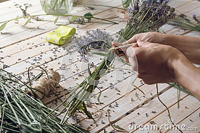 Florist at work: woman creating bouquet of natural lavender flow Stock Photo