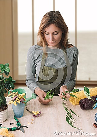 Floristry. Florist at work. Woman making bouquet of flowers. Stock Photo