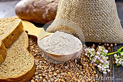 Flour buckwheat in spoon with cereals and bread on board Stock Photo