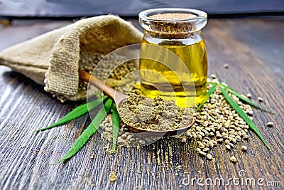 Flour hemp in spoon with grain and oil on board Stock Photo