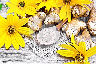 Flour of Jerusalem artichoke in spoon on old board Stock Photo