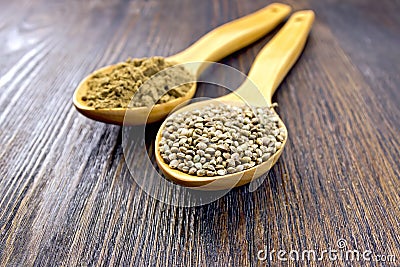 Flour and seed of hemp in spoon on board Stock Photo