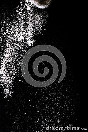 Flour sifting on a black background. White powder sift isolated on black background Stock Photo